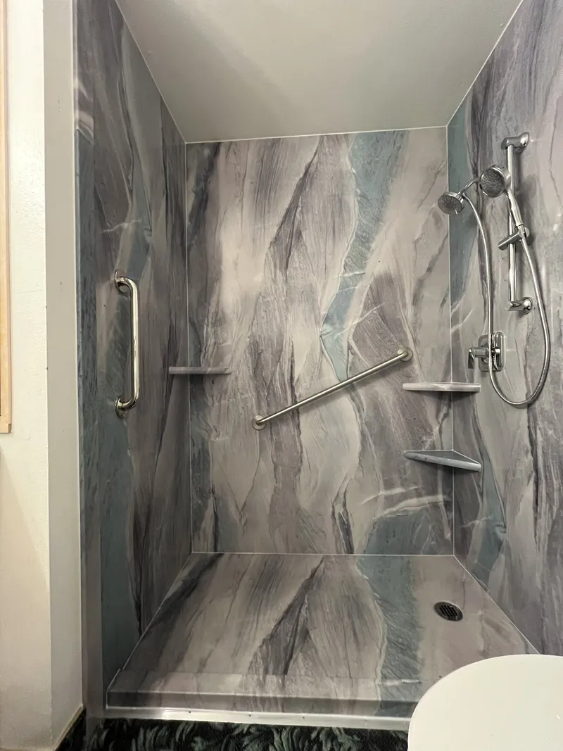 Walk-in shower with grab bar