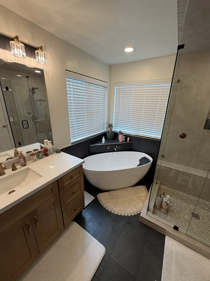 Freestanding tub, black tile floor
