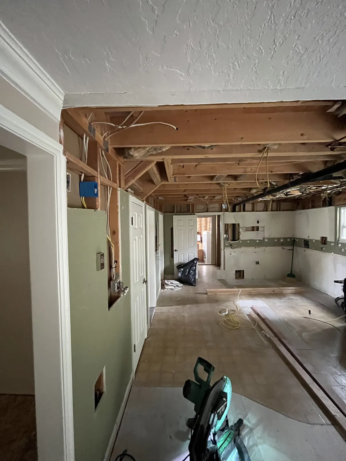 Home mid-renovation with ceiling opened and walls stripped